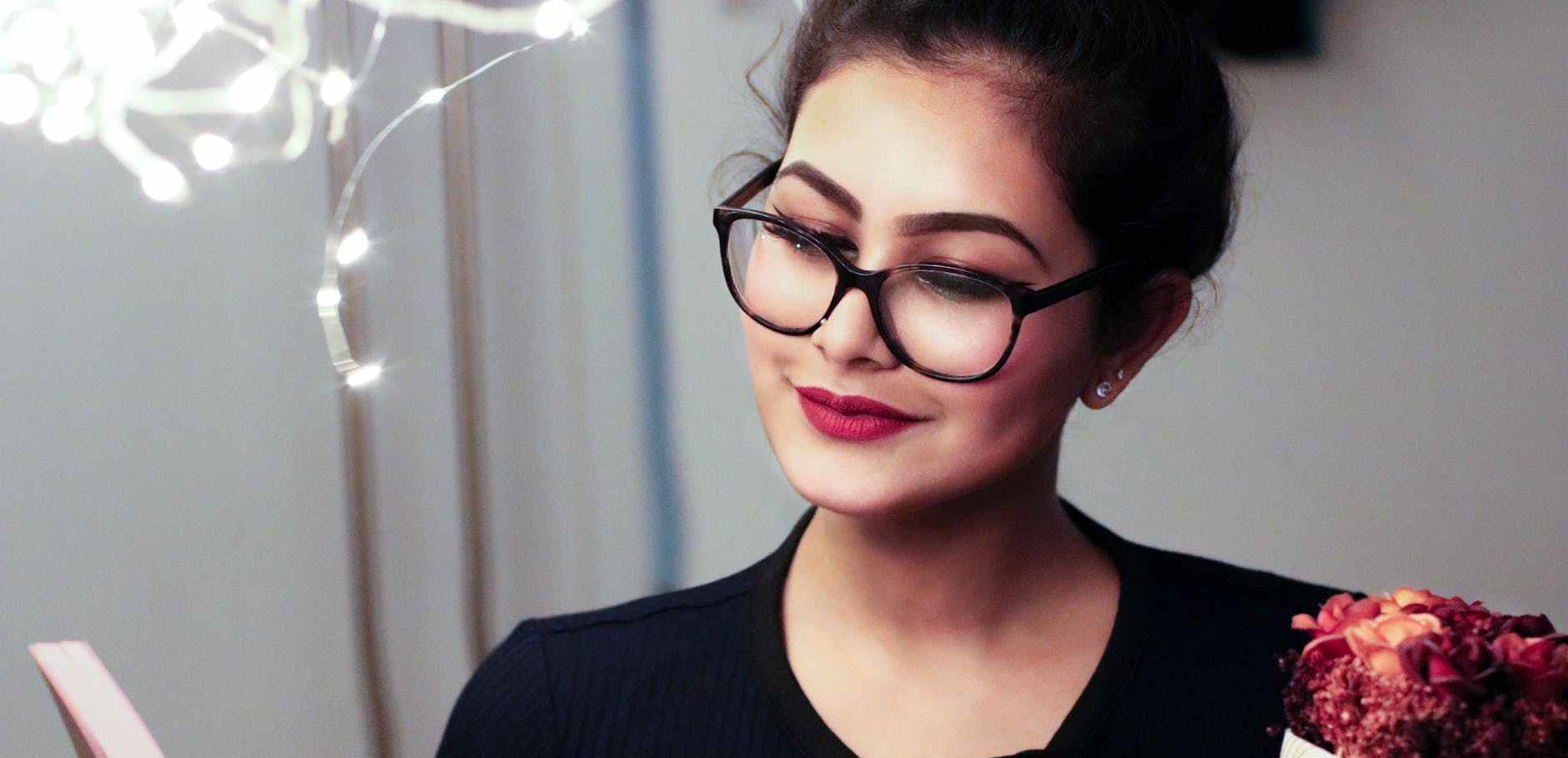 woman holding book smiling