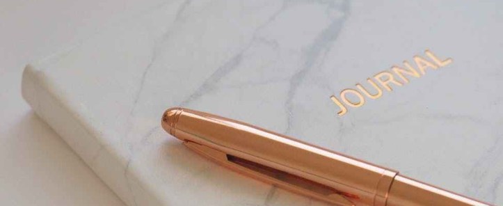 gold pen on journal book the patchwork fox