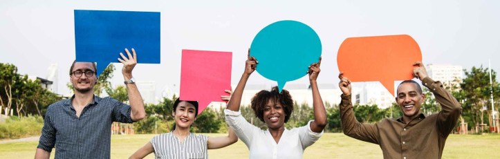 two man and two woman standing on green grass field