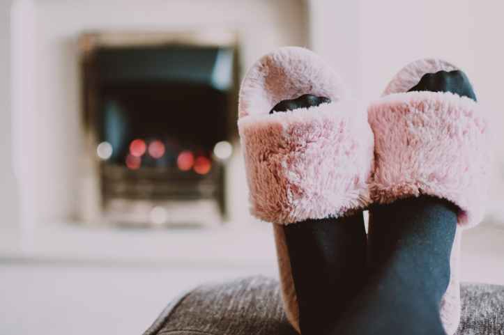 close up photography of person wearing pink house slippers