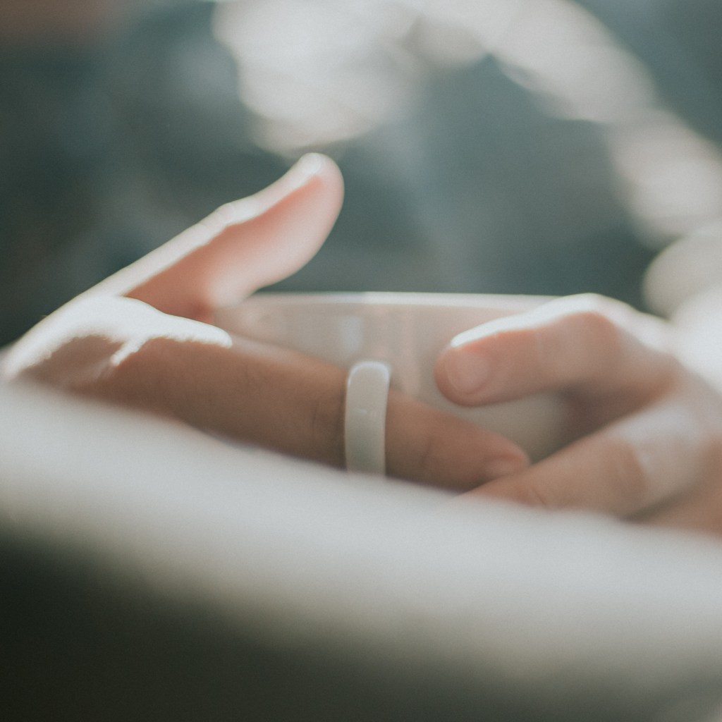 Hands holding a coffee cup