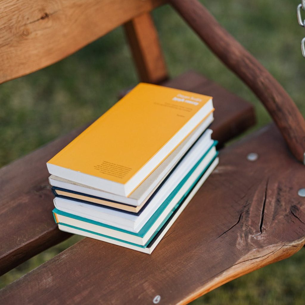 A stack of books on a wooden chair
