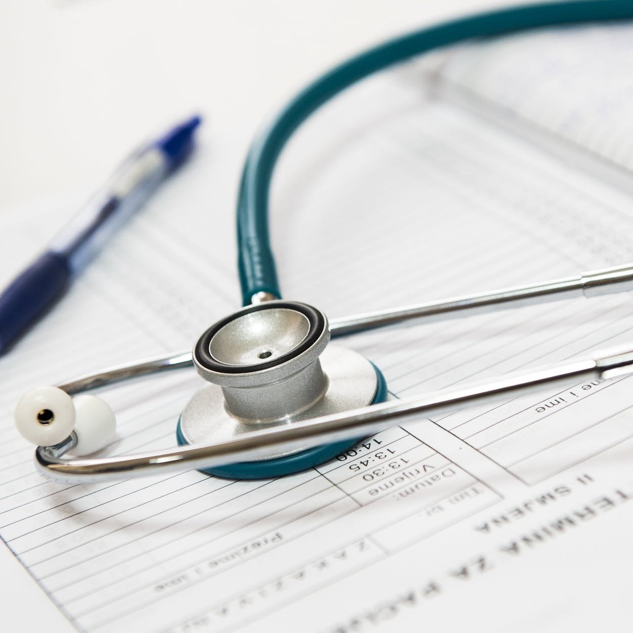 A stethoscope and pen on top of a medical chart. (wallflowerhaze.com)