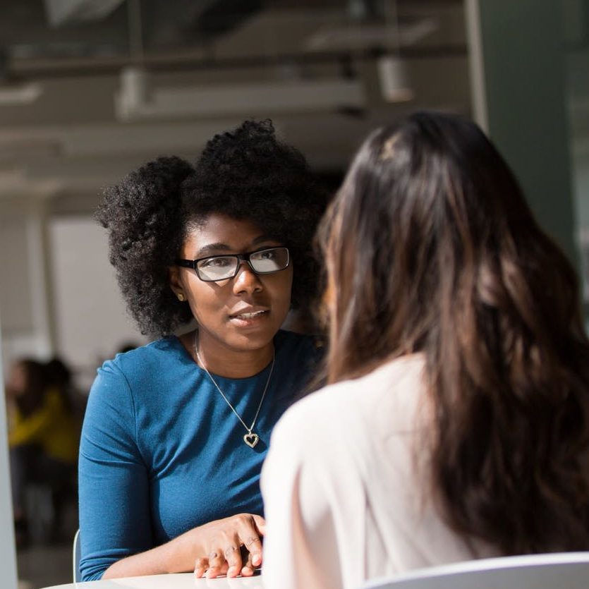 A stock photo of two women talking. (wallflowerhaze.com)