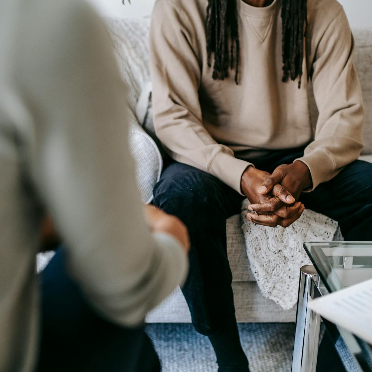A man sitting across from another man, inferring a scene of therapy.
